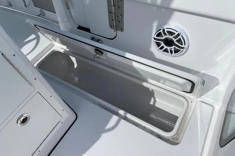 Slide: The Image of Open storage compartment on 2026 Sportsman Open 262 Center Console boat. - 12