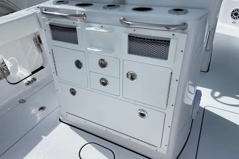 Slide: The Image of 2026 Sportsman Open 262 Center Console boat storage compartment with stainless steel handles. - 14