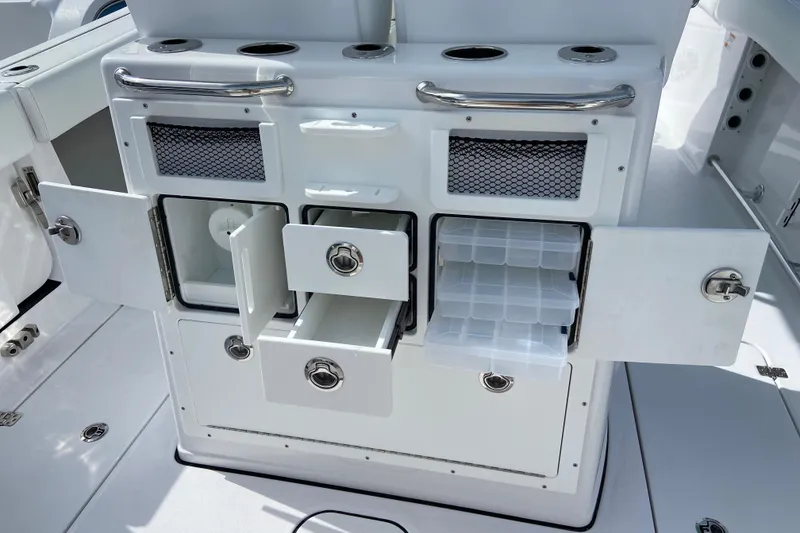 Slide: The Image of 2026 Sportsman Open 262 Center Console storage compartments with drawers and tackle boxes. - 15