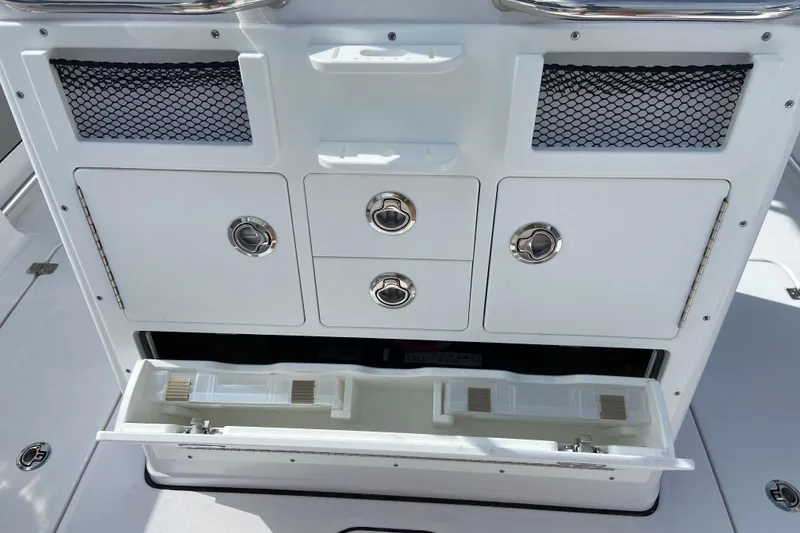 Slide: The Image of 2026 Sportsman Open 262 Center Console storage compartments with drawers and netting. - 16