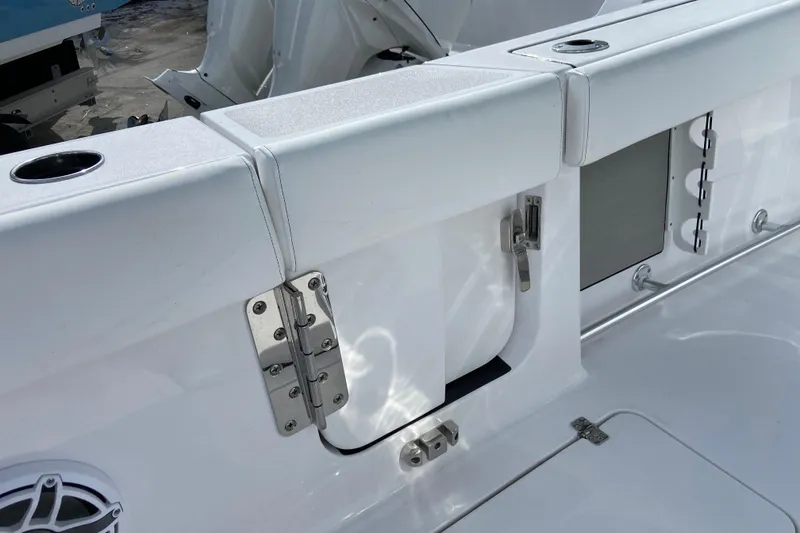 Slide: The Image of 2026 Sportsman Open 262 Center Console boat interior with stainless steel hinges and rod holders. - 17
