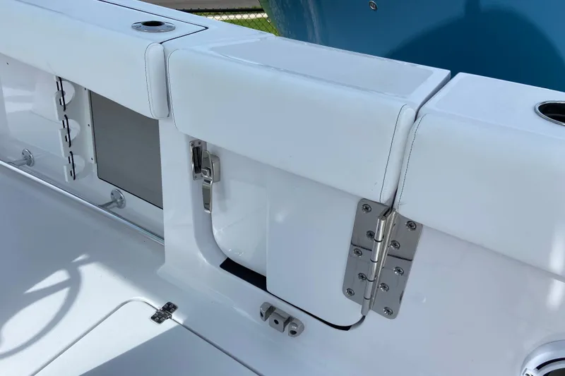 Slide: The Image of 2026 Sportsman Open 262 Center Console boat interior with white seating and stainless steel hardware. - 19