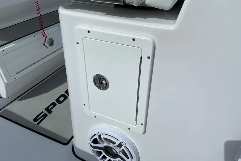 Slide: The Image of 2026 Sportsman Open 262 Center Console boat interior with storage compartment and speaker. - 21