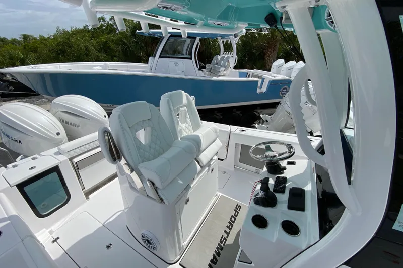 Slide: The Image of 2026 Sportsman Open 262 Center Console boat with Yamaha engines, featuring a sleek design and modern controls. - 24