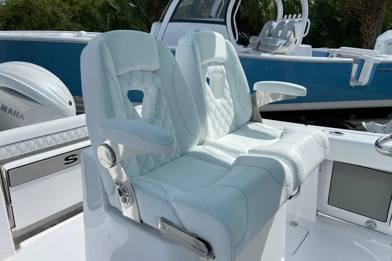 Slide: The Image of 2026 Sportsman Open 262 Center Console boat with luxurious white seating and Yamaha engine. - 26
