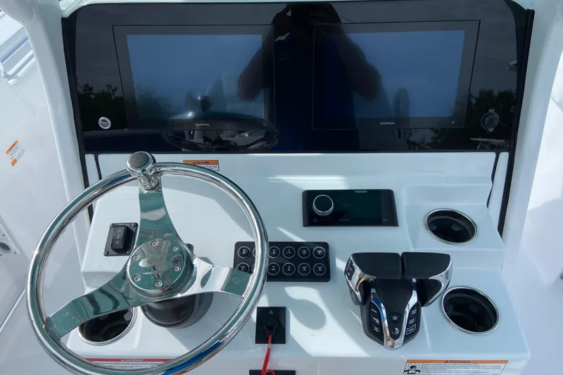 Slide: The Image of 2026 Sportsman Open 262 Center Console dashboard with steering wheel and electronic controls. - 29