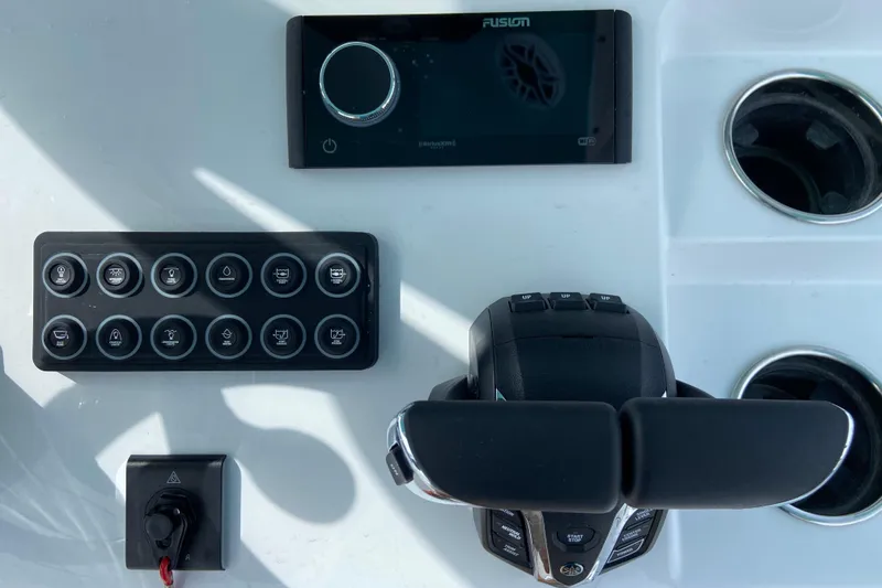 Slide: The Image of 2026 Sportsman Open 262 Center Console dashboard with controls and Fusion audio system. - 30