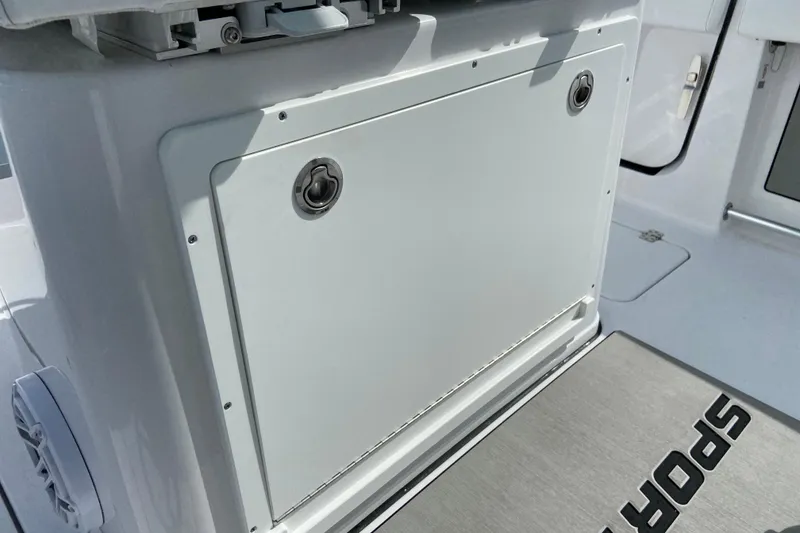 Slide: The Image of 2026 Sportsman Open 262 Center Console boat interior detail with storage compartment. - 34