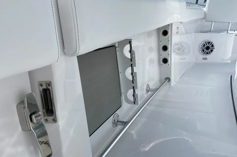 Slide: The Image of 2026 Sportsman Open 262 Center Console interior with rod holders and speakers. - 39
