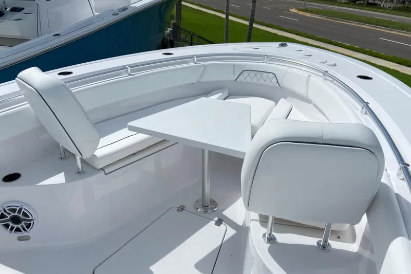 Slide: The Image of 2026 Sportsman Open 262 Center Console boat with white seating and table setup. - 43