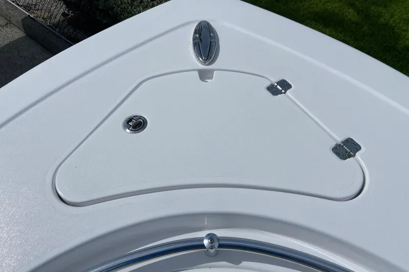 Slide: The Image of 2026 Sportsman Open 262 Center Console boat deck with storage hatch and stainless steel fittings. - 45