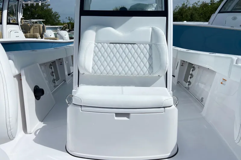 Slide: The Image of 2026 Sportsman Open 262 Center Console boat interior with white seating and storage compartments. - 47
