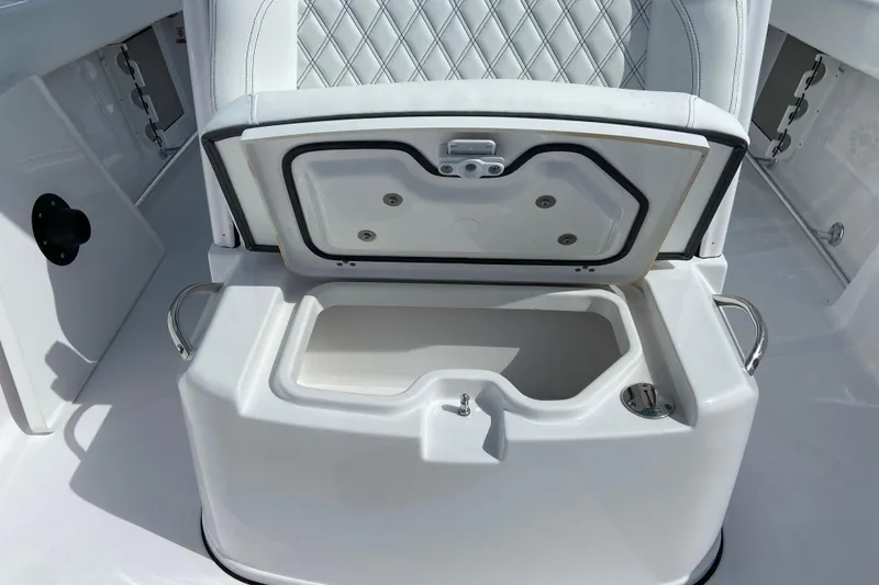 Slide: The Image of Open storage compartment on 2026 Sportsman Open 262 Center Console boat. - 48
