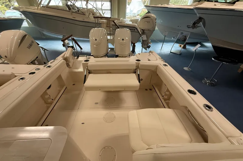 Slide: The Image of 2026 Grady-White Freedom 255 boat interior with seating and twin Yamaha engines. - 10