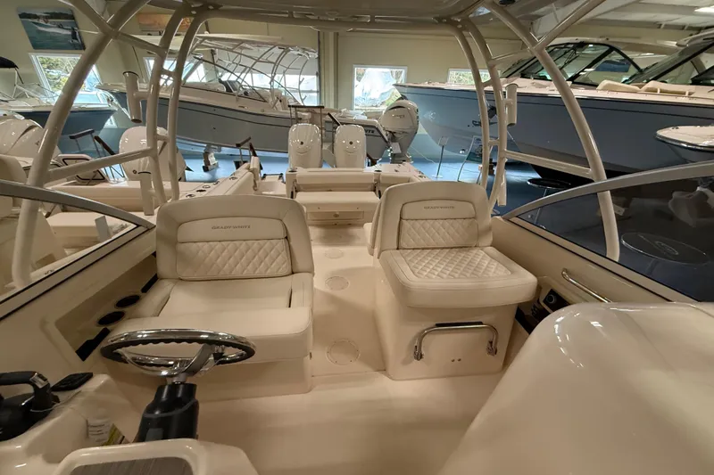 Slide: The Image of 2026 Grady-White Freedom 255 boat interior with luxurious seating and helm in showroom. - 9