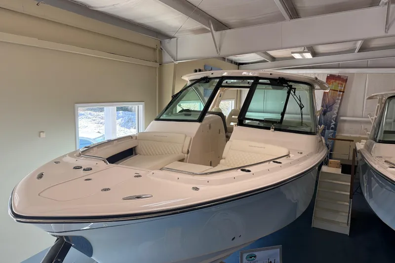 Slide: The Image of 2026 Grady-White Freedom 345 boat displayed indoors, showcasing sleek design and luxury features. - 10