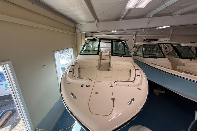 Slide: The Image of 2026 Grady-White Freedom 345 boat displayed indoors, showcasing sleek design and spacious seating. - 11