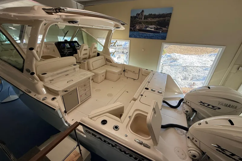Slide: The Image of 2026 Grady-White Freedom 345 boat interior with Yamaha engines, showcasing luxury seating and controls. - 12