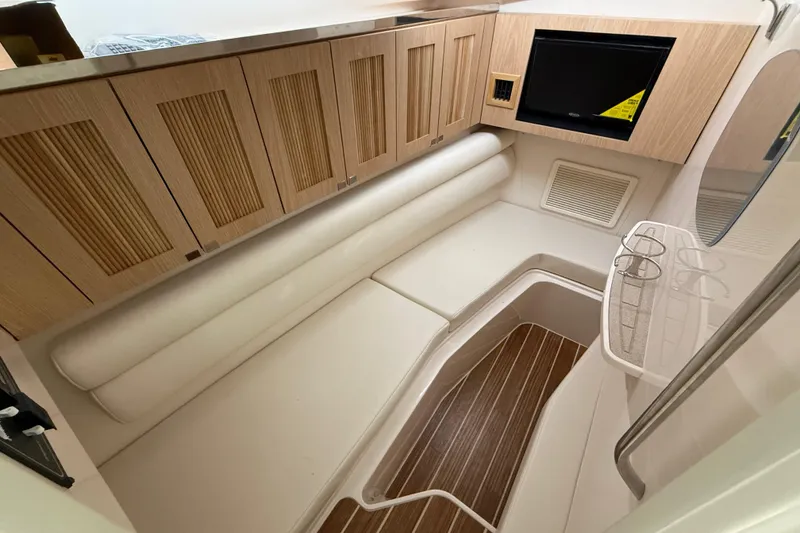 Slide: The Image of 2026 Grady-White Freedom 345 cabin interior with wood accents and seating area. - 18