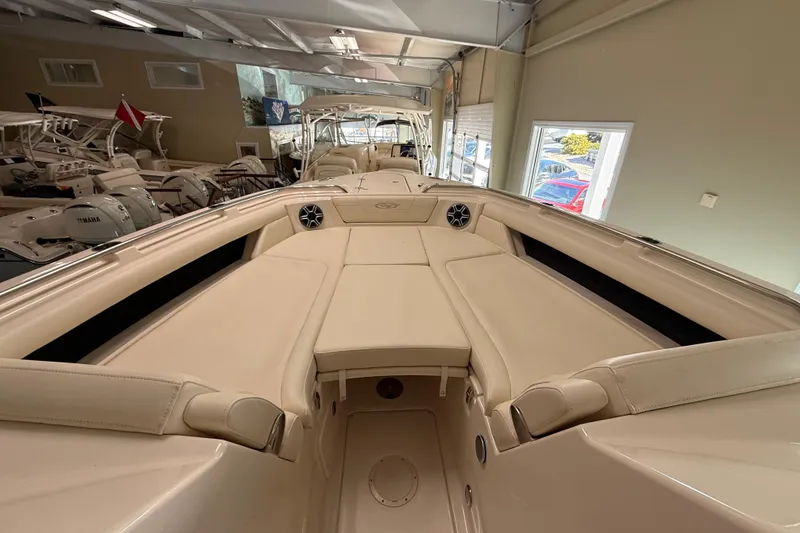 Slide: The Image of 2026 Grady-White Freedom 345 boat interior with beige seating in showroom. - 20