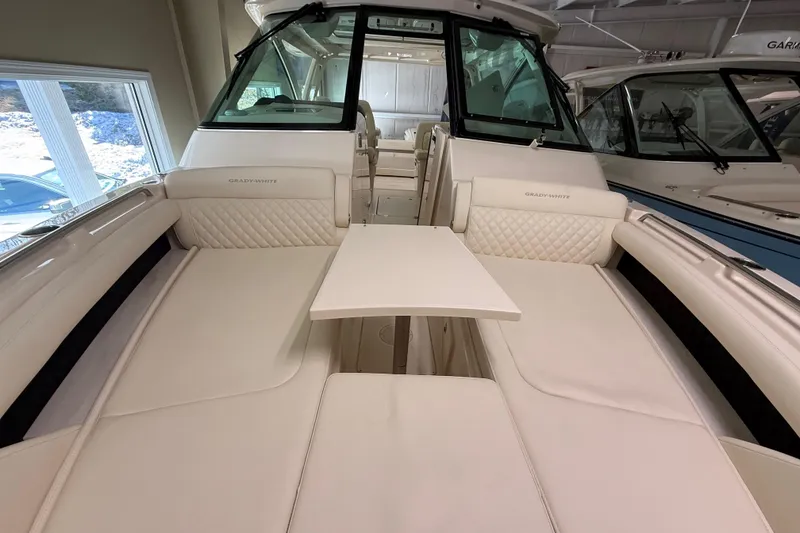 Slide: The Image of 2026 Grady-White Freedom 345 boat interior with white seating and table. - 22