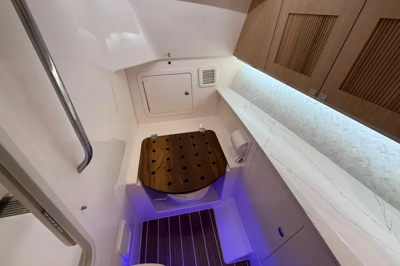 Slide: The Image of Luxurious 2026 Grady-White Freedom 345 boat bathroom with modern fixtures and wood accents. - 23