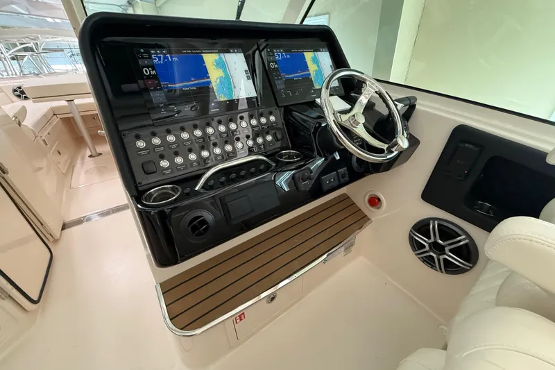 Slide: The Image of 2026 Grady-White Freedom 345 helm with advanced navigation displays and controls. - 27