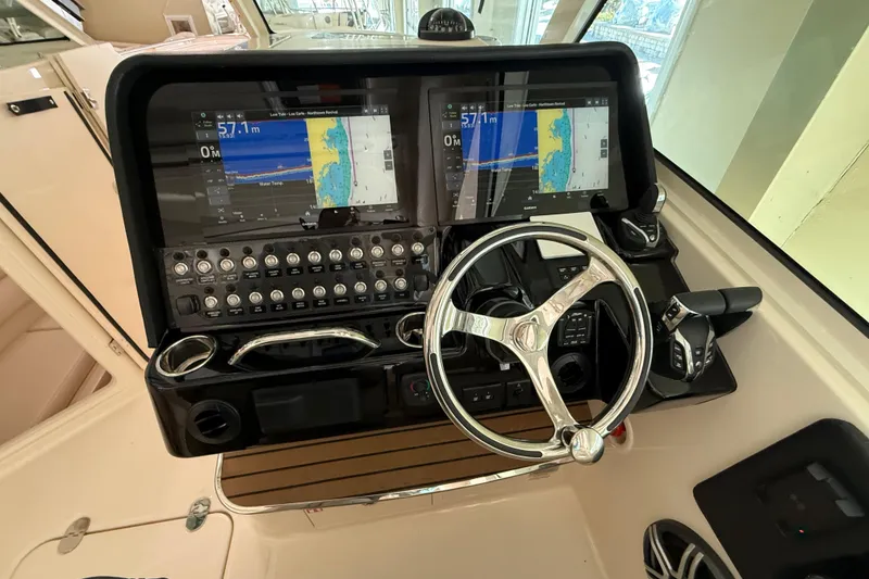 Slide: The Image of Helm of 2026 Grady-White Freedom 345 with dual navigation screens and controls. - 28