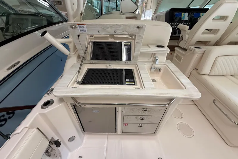 Slide: The Image of Luxury Grady-White Freedom 345 boat interior with grill and sink, 2026 model. - 33