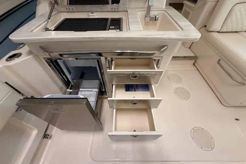 Slide: The Image of 2026 Grady-White Freedom 345 boat interior with open drawers and sink area. - 35