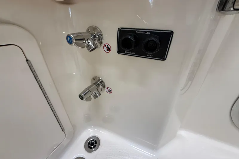 Slide: The Image of 2026 Grady-White Freedom 345 boat engine flush controls and water outlets. - 42