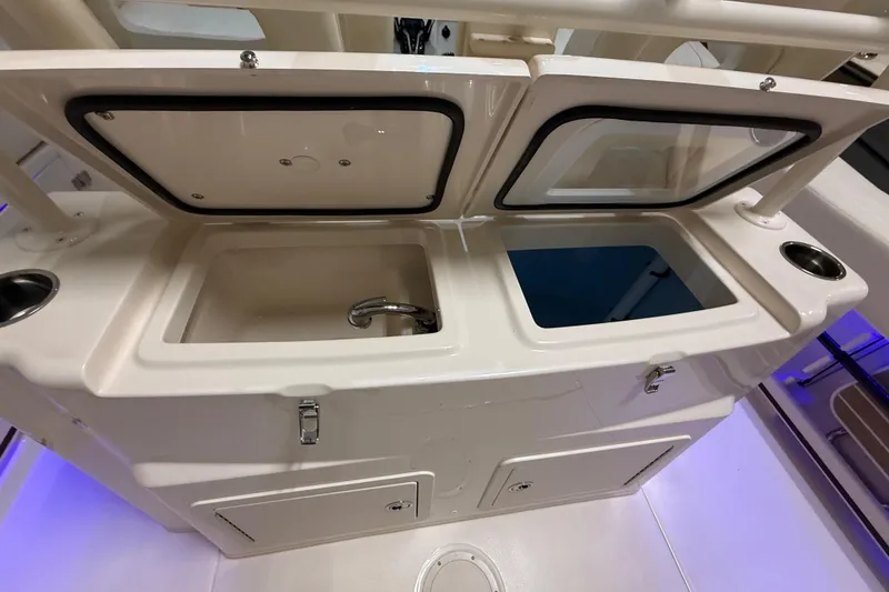 Slide: The Image of 2026 Grady-White Canyon 306 boat interior with sink and storage compartments. - 18