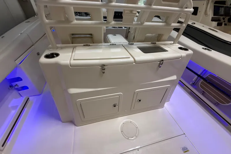 Slide: The Image of 2026 Grady-White Canyon 306 boat interior with storage compartments and blue LED lighting. - 19