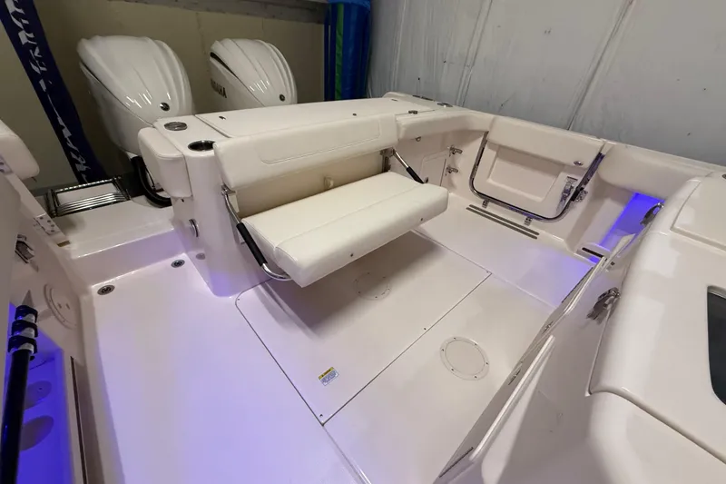 Slide: The Image of 2026 Grady-White Canyon 306 boat interior with seating and dual engines. - 21