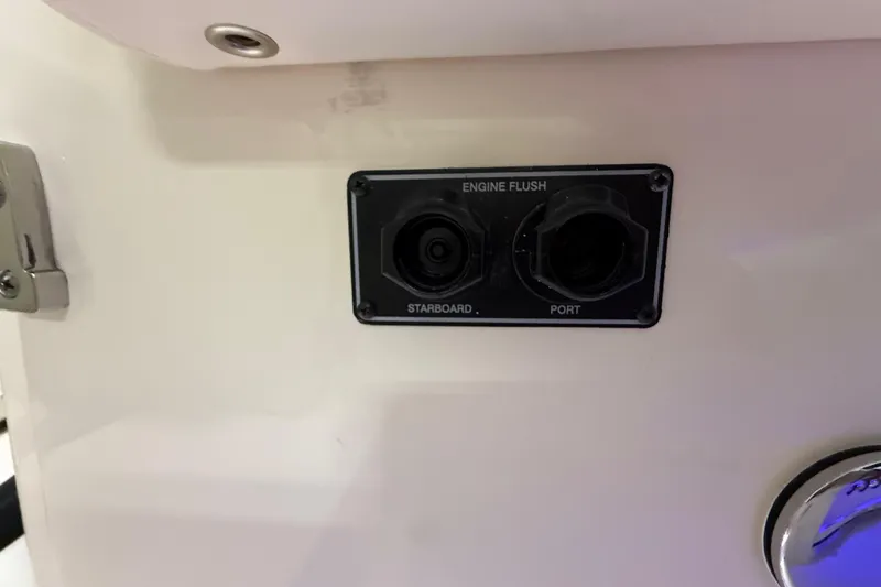 Slide: The Image of Engine flush ports on 2026 Grady-White Canyon 306 boat, labeled starboard and port. - 25