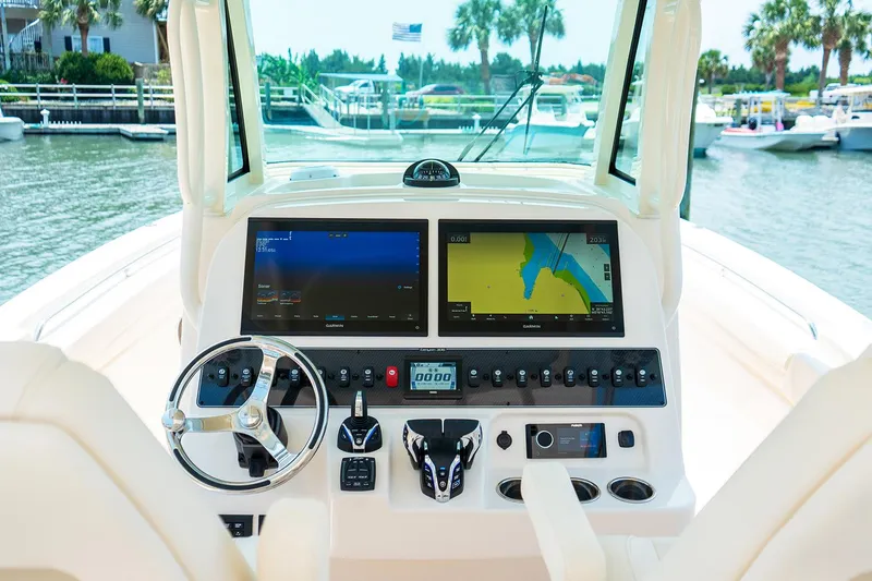 Slide: The Image of Manufacturer Provided Image: 2025 Grady-White Canyon 306 boat dashboard with navigation screens and controls. - 32