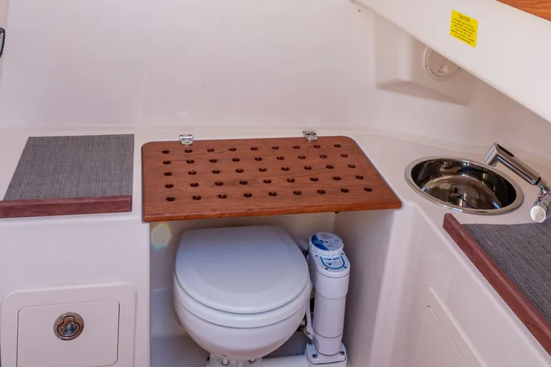 Slide: The Image of Manufacturer Provided Image: 2025 Grady-White Canyon 306 boat interior with toilet and sink. - 35