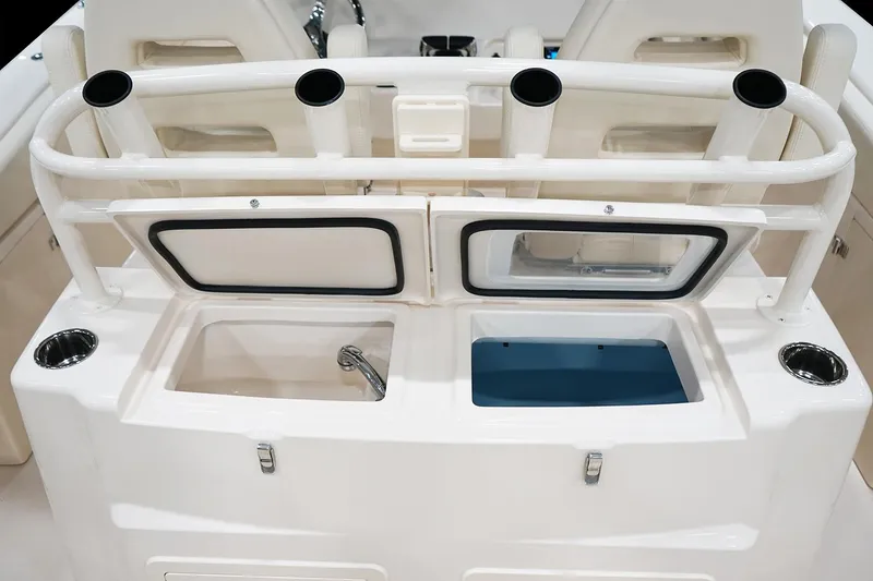 Slide: The Image of Manufacturer Provided Image: 2025 Grady-White Canyon 306 boat interior, featuring rod holders and storage compartments. - 9