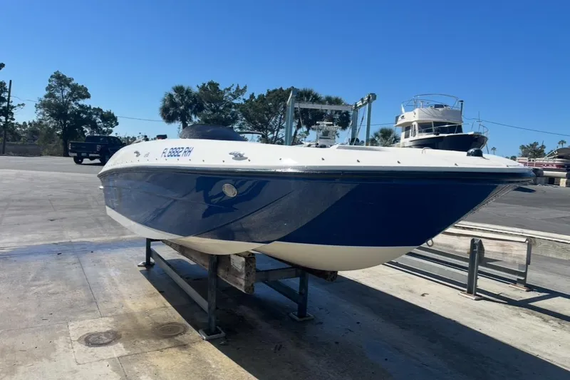 Slide: The Image of 2017 Bayliner Element E18 boat on trailer, parked outdoors under clear blue sky. - 7