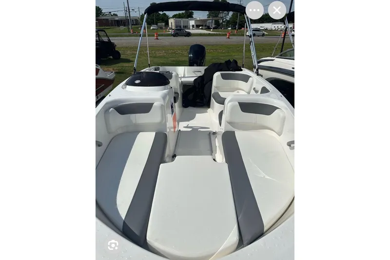 Slide: The Image of 2017 Bayliner Element E18 boat interior with white seating and open deck layout. - 9
