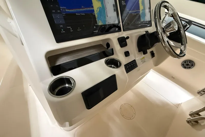 Slide: The Image of 2026 Grady-White Canyon 326 helm with dual displays and stainless steel steering wheel. - 11