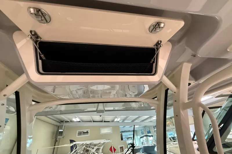 Slide: The Image of 2026 Grady-White Canyon 326 boat interior storage compartment with open hatch. - 13