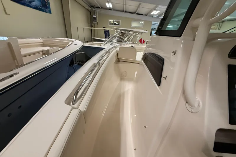 Slide: The Image of 2026 Grady-White Canyon 326 boat interior view in showroom setting. - 15