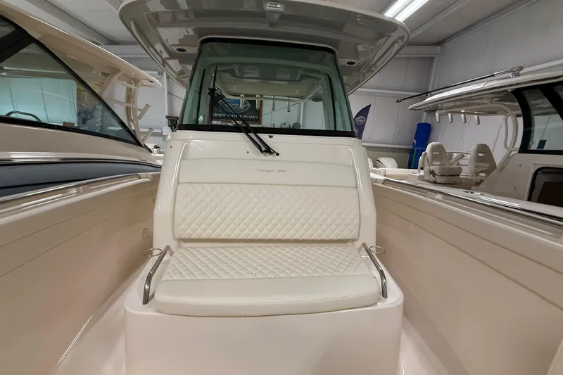 Slide: The Image of 2026 Grady-White Canyon 326 boat interior with cushioned seating in showroom. - 17