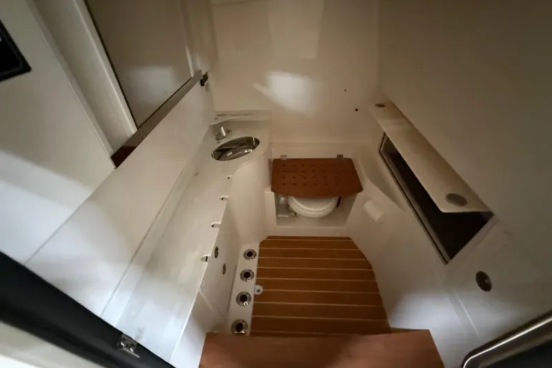 Slide: The Image of Interior of 2026 Grady-White Canyon 326 boat bathroom with modern fixtures and wooden flooring. - 20