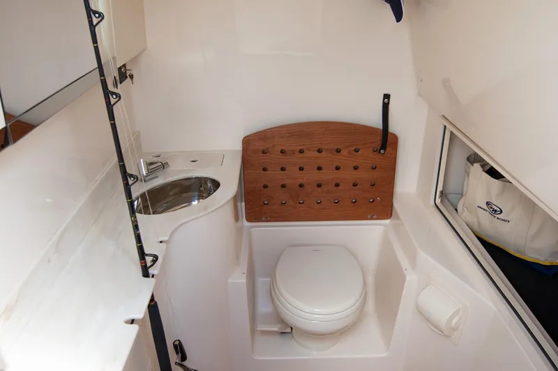 Slide: The Image of Manufacturer Provided Image: 2025 Grady-White Canyon 326 boat interior with compact bathroom and sink. - 21