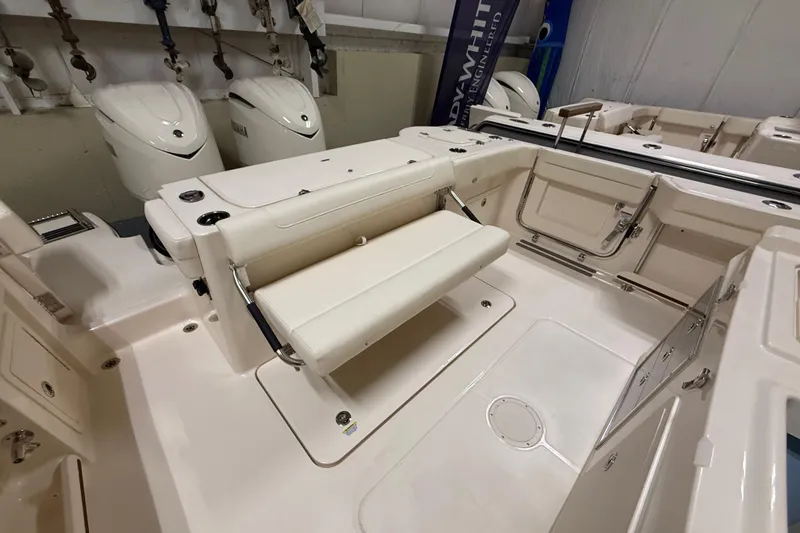 Slide: The Image of 2026 Grady-White Canyon 326 boat interior with seating and Yamaha engines. - 23