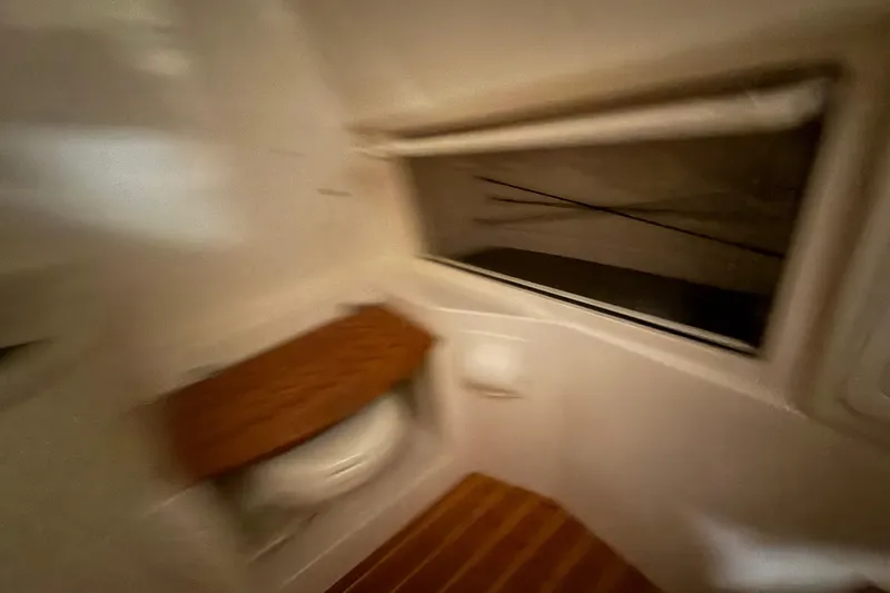 Slide: The Image of Interior view of 2026 Grady-White Canyon 326 boat cabin with window and seating. - 31