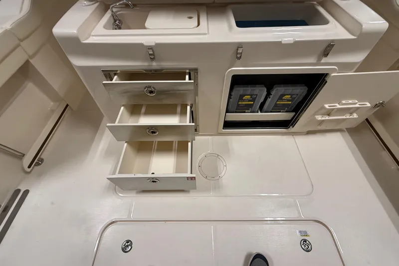 Slide: The Image of 2026 Grady-White Canyon 326 boat interior with storage drawers and sink. - 6