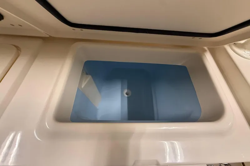 Slide: The Image of Livewell compartment on 2026 Grady-White Canyon 326 boat, featuring a clean, spacious design. - 7